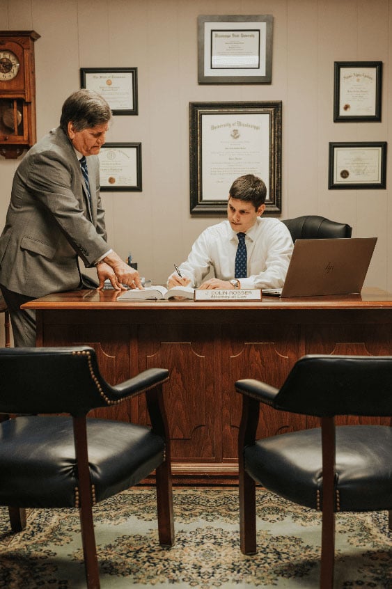 Image of Attorneys Richard G. Rosser and J. Colin Rosser at a desk working together.